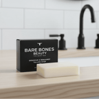 Bare Bar - Geranium & Bergamot Tallow Soap - 90g by Bare Bones Beauty displayed with black box on wooden vanity.