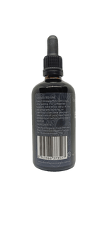 Back label of Black Seed Oil - 100ml with usage instructions, ingredients, barcode, and Barefoot Skincare Co branding in dark glass bottle