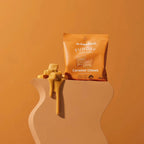 Funday Caramel Chews - 45g package with caramel pieces and caramel sauce dripping on a beige stand