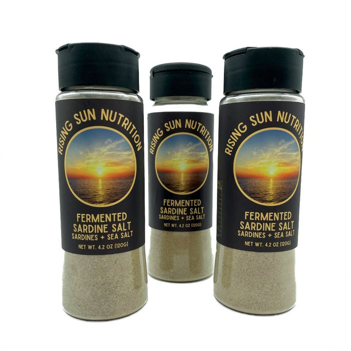 Three jars of Fermented Sardine Salt - 120g by Rising Sun Nutrition with a sunset ocean label on black lids