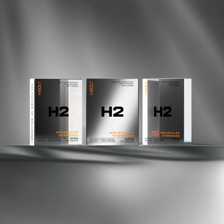 Three reflective silver boxes of H2 Hydrogen Water - Unflavoured - 30 Tablets by Healr displayed on a grey surface