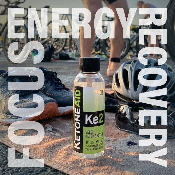 KE2 Ketone Ester Drink - 100ml bottle outdoors with bike gear, highlighting energy, focus, recovery by Ketoneaid.
