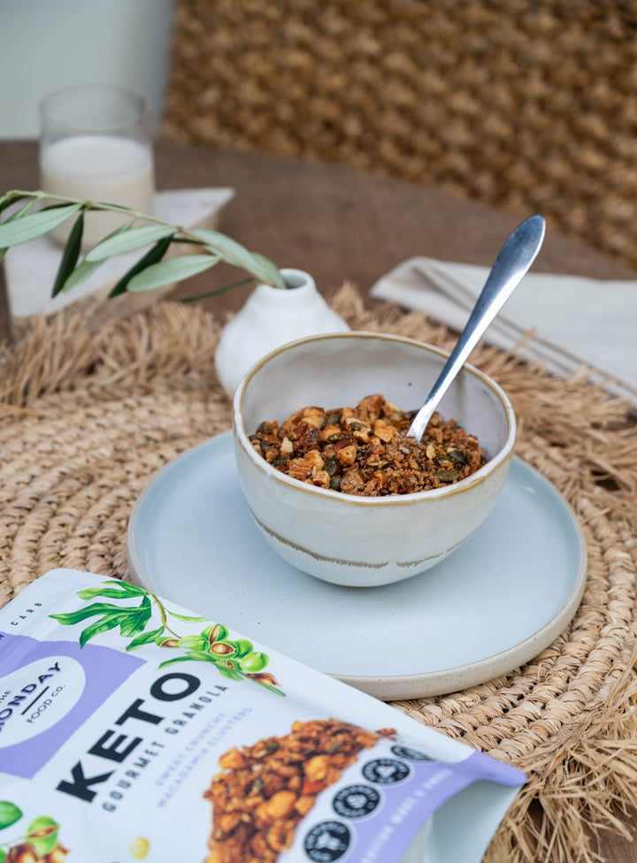 Keto Gourmet Granola - Sweet Crunchy Macadamia Clusters - 800g by The Monday Food Co displayed in bowl with spoon and packaging nearby