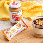 Protein Cookie Bar - Forty Thieves Peanut Butter - 60g with peanut butter jar and peanut butter dessert on wooden board