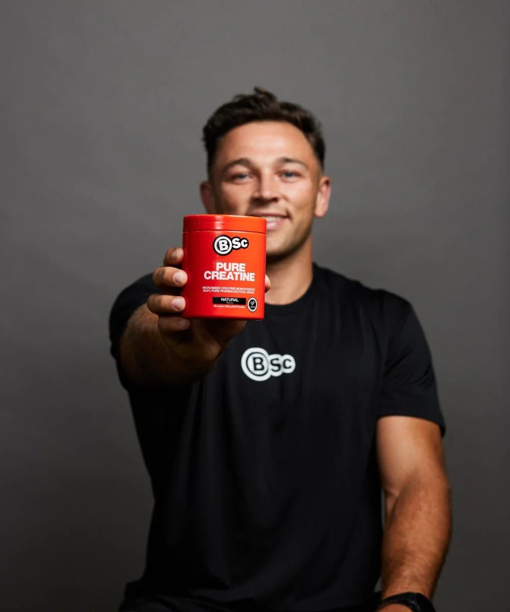 Man holding BSc Supplements Pure Creatine - 200g container, promoting Dirty Keto, Low Carb, and Creatine collections.