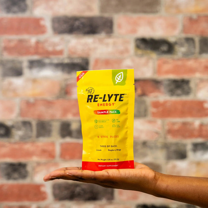 Re-Lyte Energy - Sample Pack - 6 sticks - Best Before 28 Feb 2026 held on hand with brick wall background