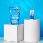 Restore Electrolyte Drink Mix Blue Raspberry 240g pouch with blue raspberry drink on white pedestals, bright background