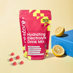 Restore Electrolyte Drink Mix Raspberry Lemonade 240g pouch with raspberries and lemon halves displayed on light background
