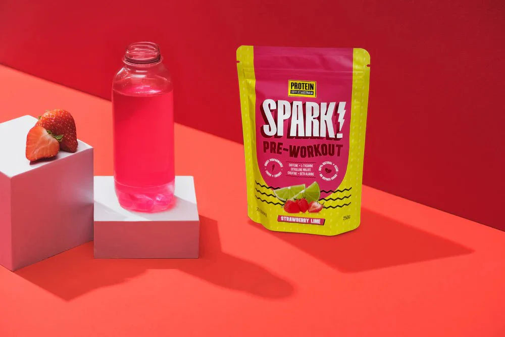 Spark Pre-workout - Strawberry Lime - 250g by Protein Supplies Australia with fresh strawberries and pink drink on red background