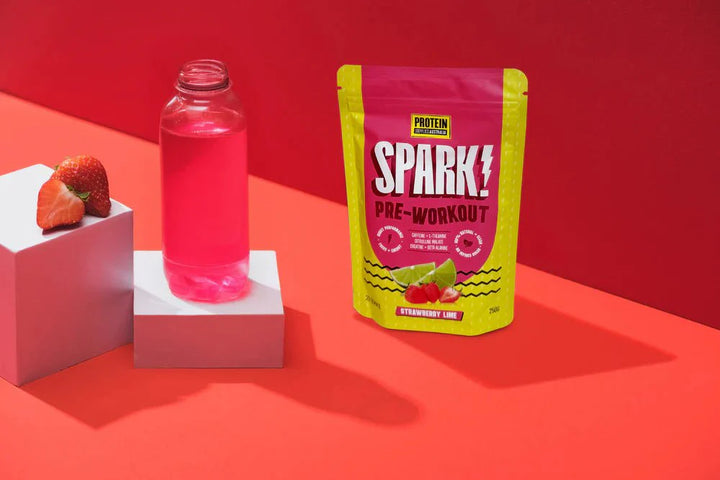 Spark Pre-workout - Strawberry Lime - 250g by Protein Supplies Australia with fresh strawberries and pink drink on red background