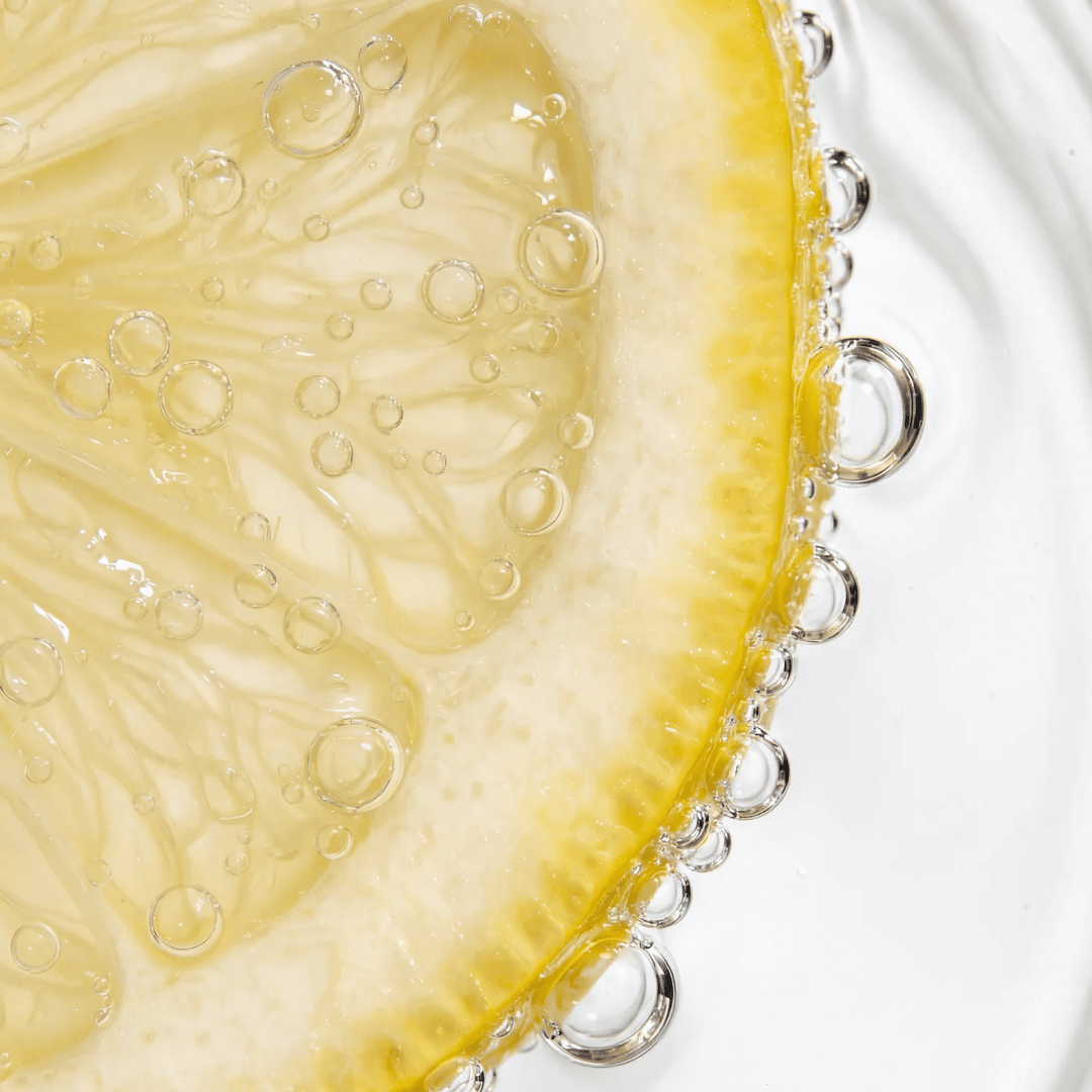 Close-up of a fresh lemon slice with bubbles in water, representing Dr. Hydrate Yuzu Lemon Jar - 30 Serves.
