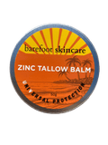 Round metal tin of Zinc Tallow Balm - 130g by Barefoot Skincare Co with orange tropical sunset label design
